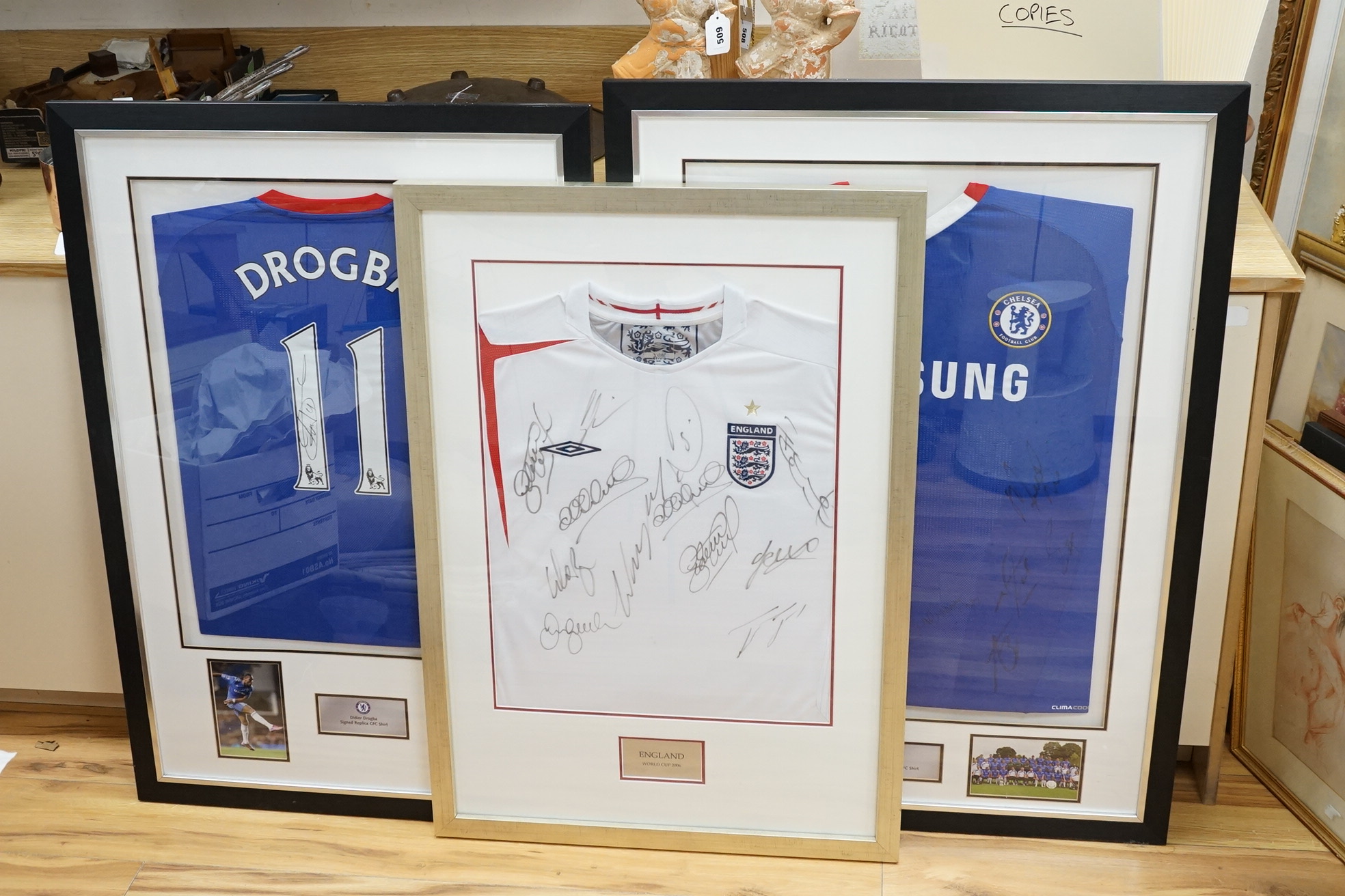 Three signed football shirts, to include England World Cup 2006 and Didier Drogba signed replica CFC shirt, framed. Condition - good